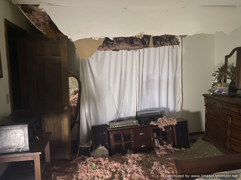 Upstairs guest room.  Note the collapsed floor by the window.